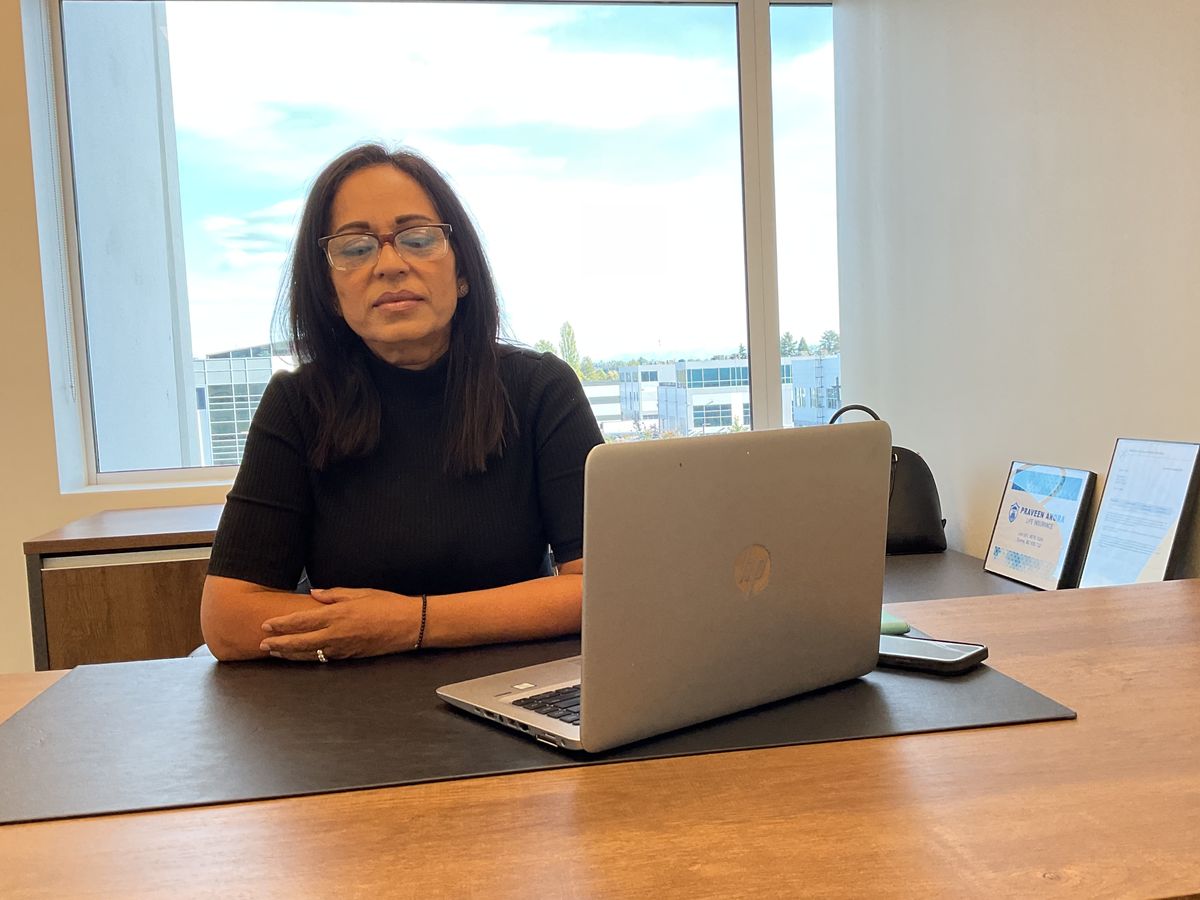 Praveen Arora at her office desk